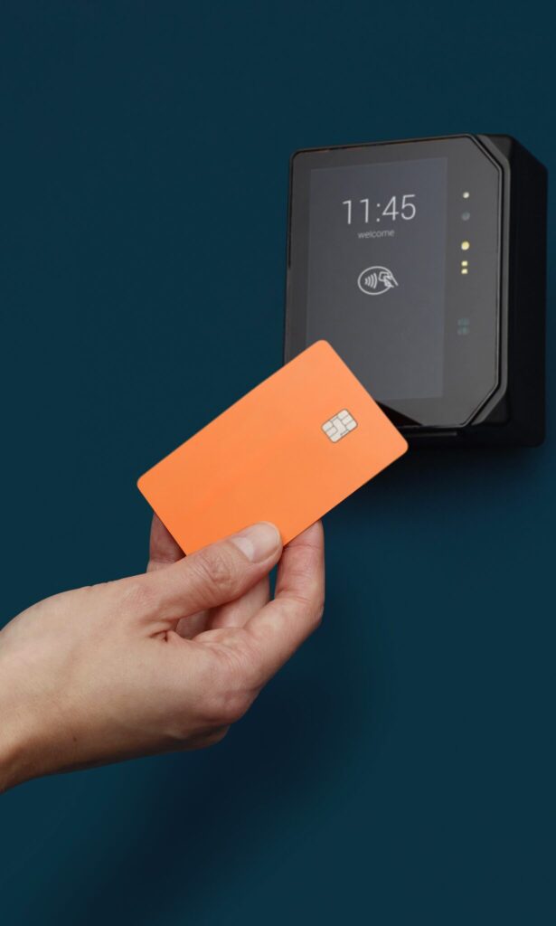 A Hand with a Keycard Paying at an Unattended Self Service Kiosk